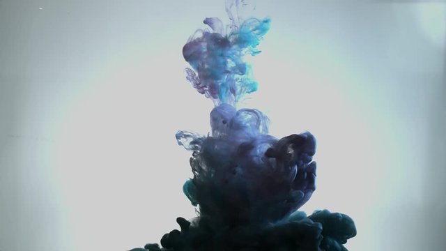 Smoky blue and pink ink in motion on water. Abstract pattern with blue colours ink in water. Blue Smoke goes down