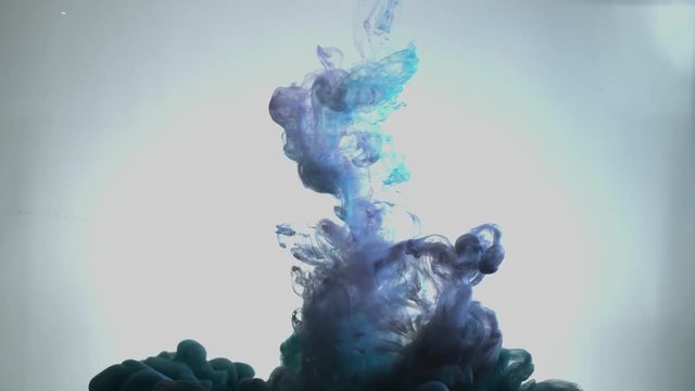 Smoky blue and pink ink in motion on water. Abstract pattern with blue colours ink in water. Blue Smoke goes down