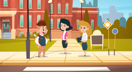 Group Of Pupils Stand In Front Of School Building Primary Schoolchildren Talking Students Flat Vector Illustration