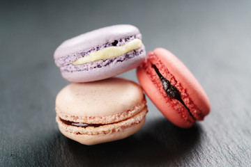 three mixed macarons on slate board
