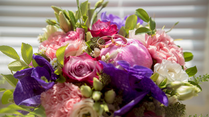 Wedding bouquet with golden rings, macro