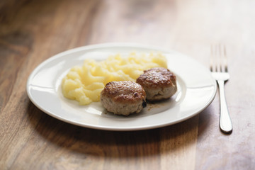 homemade cutlet with mashed potatoes on wood table