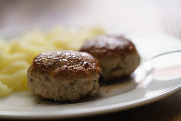 homemade cutlet with mashed potatoes on wood table