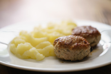 homemade cutlet with mashed potatoes on wood table