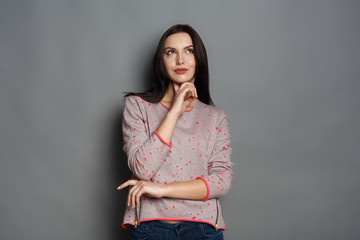 Pensive young woman looking upwards