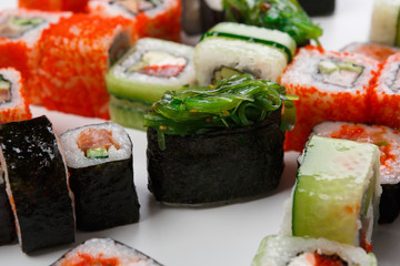 Set of sushi, maki and rolls on white background