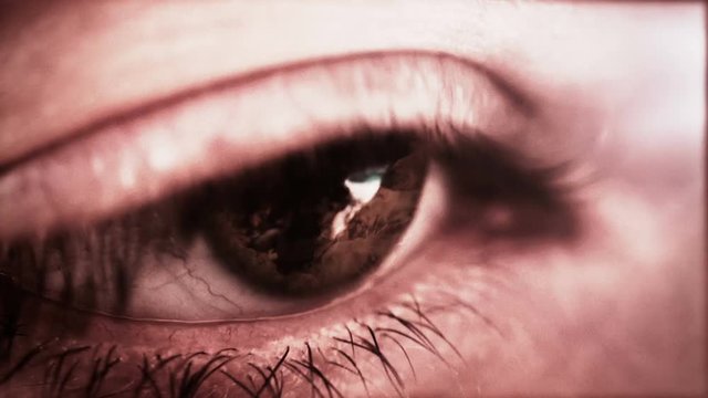 Fire reflecting in the pupil of a woman's eye.