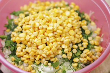 Fresh salad with canned corn, cabbage and parsle