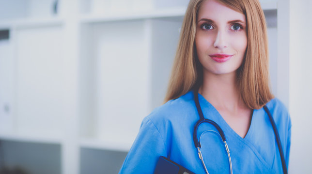 Doctor woman is standing in the near window