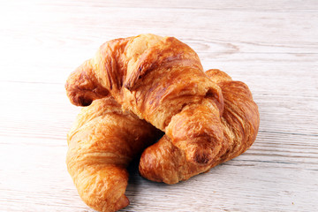 freshly baked croissants on white board, bakery concept