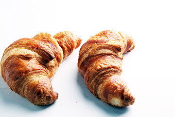 freshly baked croissants on white board, bakery concept