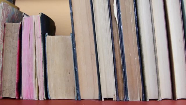 Vintage books. View of row of old books and vintage typewriter