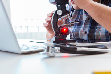 High precision engineering with man working with microscope