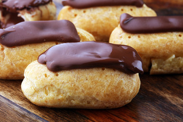 Traditional French dessert. Eclair with chocolate icing. Pastery concept