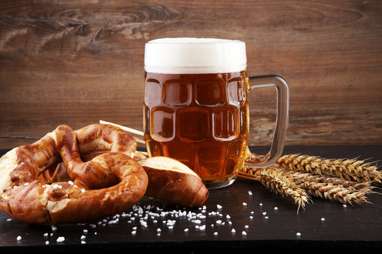 Beer in a mug. Oktoberfest salted soft pretzels and beer from Germany