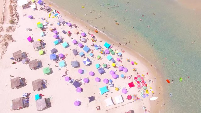 Tropical beach with colorful umbrellas - Top down aerial view