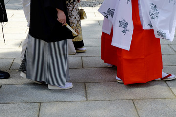 Japanese people in traditional clothes are walking in wedding ceremony