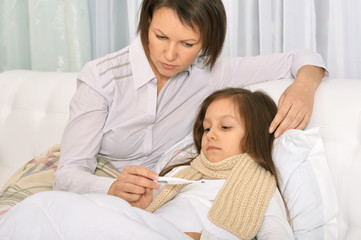 Mother taking care of daughter