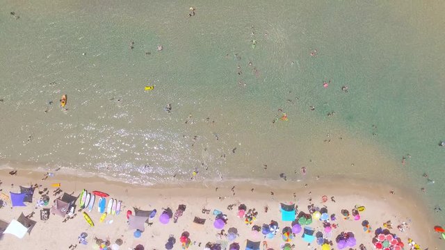 Tropical beach with colorful umbrellas - Top down aerial view