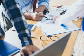 Business concept. Business people discussing the charts and graphs showing the results of their successful teamwork
