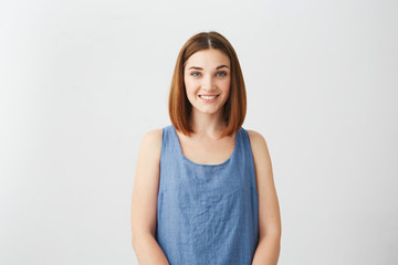 Portrait of young happy cheerful beautiful girl smiling looking at camera over white background.