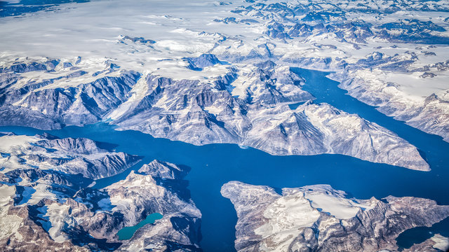 Aerial view of Greenland with fjords, glaciers and mountains on a sunny day