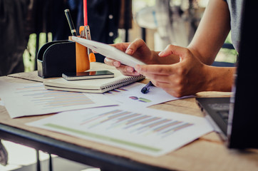 business documents on office table with laptop computer and graph financial diagram and Business...