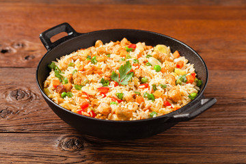 Fried rice with chicken. Prepared and served in a wok.