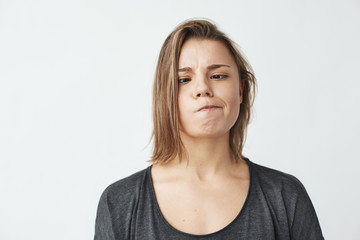 Portrait of cheerful happy beautiful girl smiling making funny face over white background.