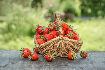 Strawberries in a basket on a wooden table