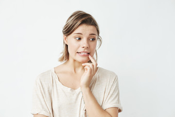 Young beautiful girl ashamed looking in side over white background. 