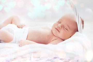 Obraz na płótnie Canvas Newborn baby girl, 7 days old, sleeping on soft blanket in a basket