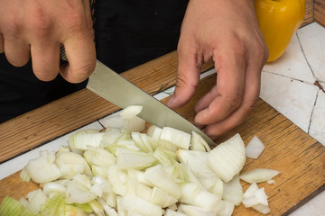 Onion cutting on a wooden cutting board