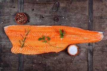 Fotobehang salmon fillet with spices on a wooden background © Vaceslav Romanov