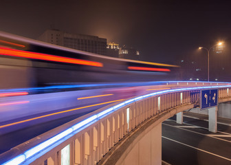 Fototapeta na wymiar Night scene with illuminated bridge and traffic in motion blur, Beijing center, China