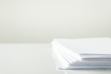 blank papers on white table,blank stack documents paper on office desk.