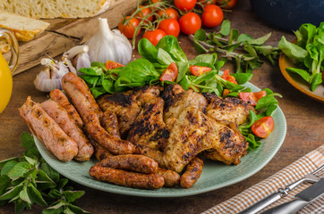 Grilled chicken wings and sausages