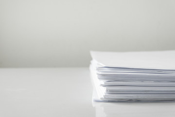 blank papers on white table,blank stack documents paper on office desk.