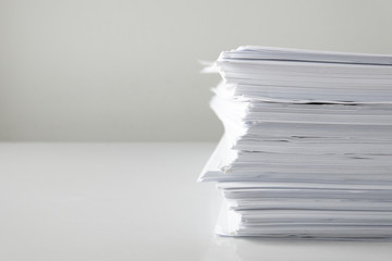 blank papers on white table,blank stack documents paper on office desk.