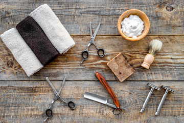 Fototapeta na wymiar Barbershop. Men's shaving and haircut. Brush, razor, foam, sciccors on wooden table background top view