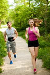 Fototapeta premium Active young couple running in the park
