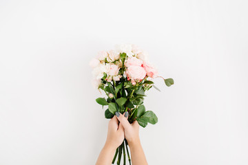 Beautiful pink rose flower bouquet in girls hand isolated on white background. Flat lay, top view. Floral composition
