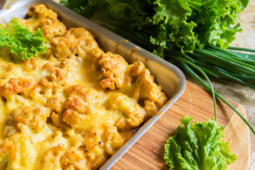 Cauliflower in batter under cheese crust on a tray