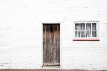 Fototapeta na wymiar Door and window on a white wall
