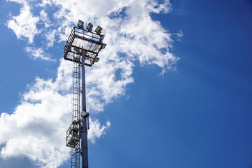 Stadium lighting pole light field at day bright blue