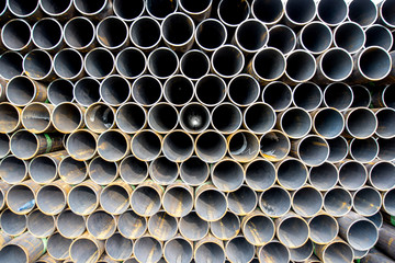 View on the pile of rusty steel pipes outdoors