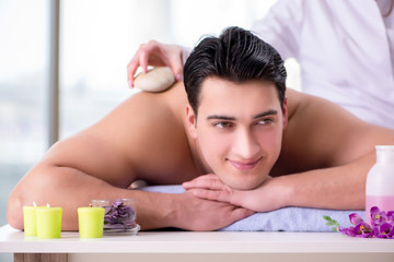 Fototapeta na wymiar Handsome man in spa massage concept