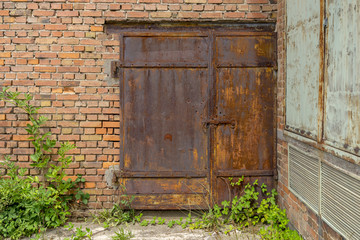 Old rusted big iron door of a building