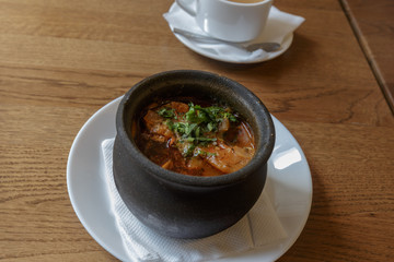 Traditional Georgian soup Kharcho with meat and rice on wooden background