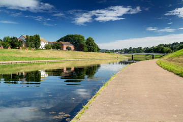 View of the Exe River Canal in Exeter. Sunny calm morning. You can see a car bridge through the canal. Exeter. Devon. England